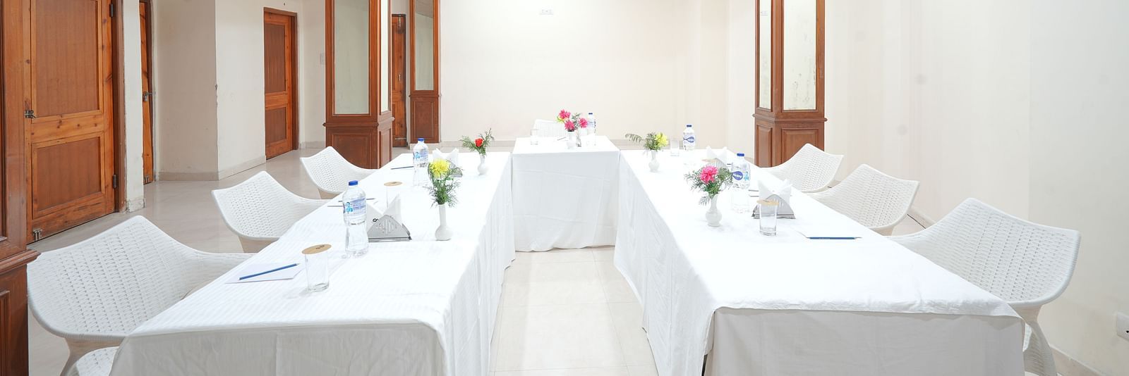 Conference hall with chairs and tables neatly arranged at DLS Hotels The Rock Castle.